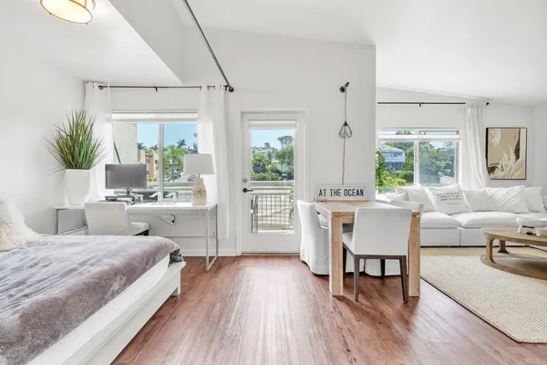 a bedroom with a bed and a table chair