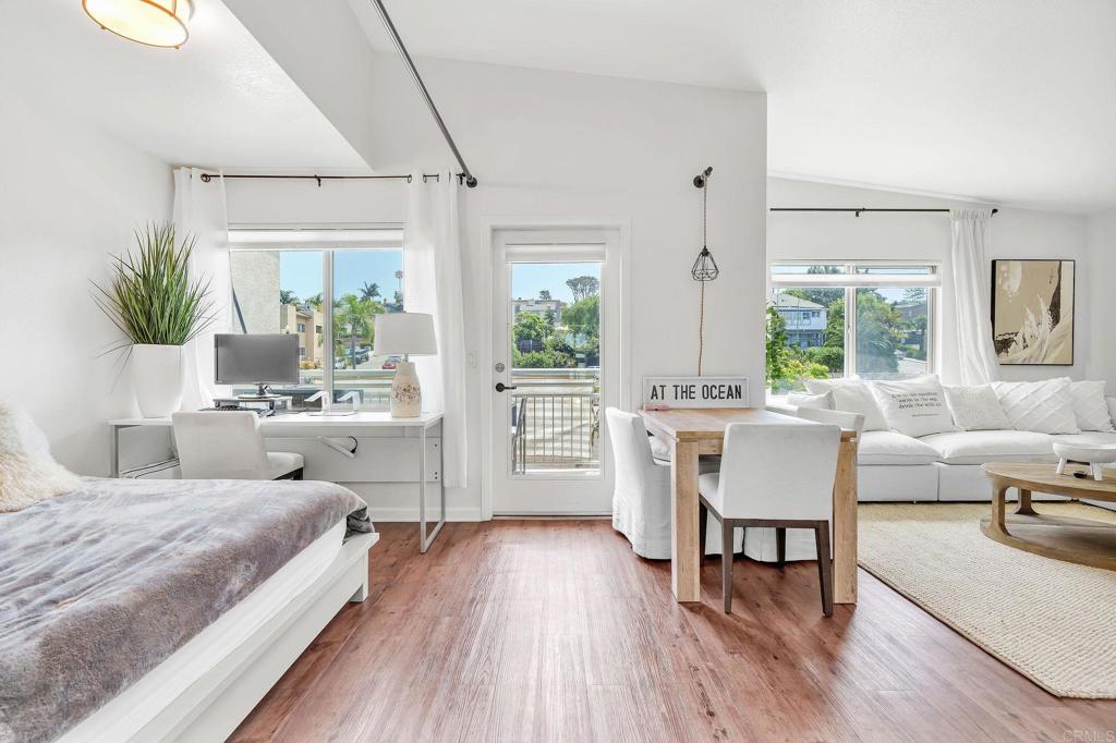 687 South Coast Highway 101, Unit 302 Encinitas, CA 92024 - Photo 17 of 32 a bedroom with a bed and a table chair