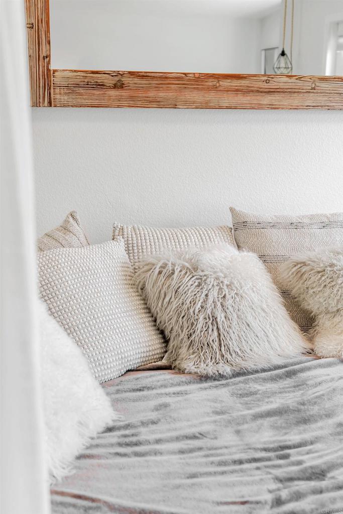 687 South Coast Highway 101, Unit 302 Encinitas, CA 92024 - Photo 20 of 32 a bed with a white comforter and pillows