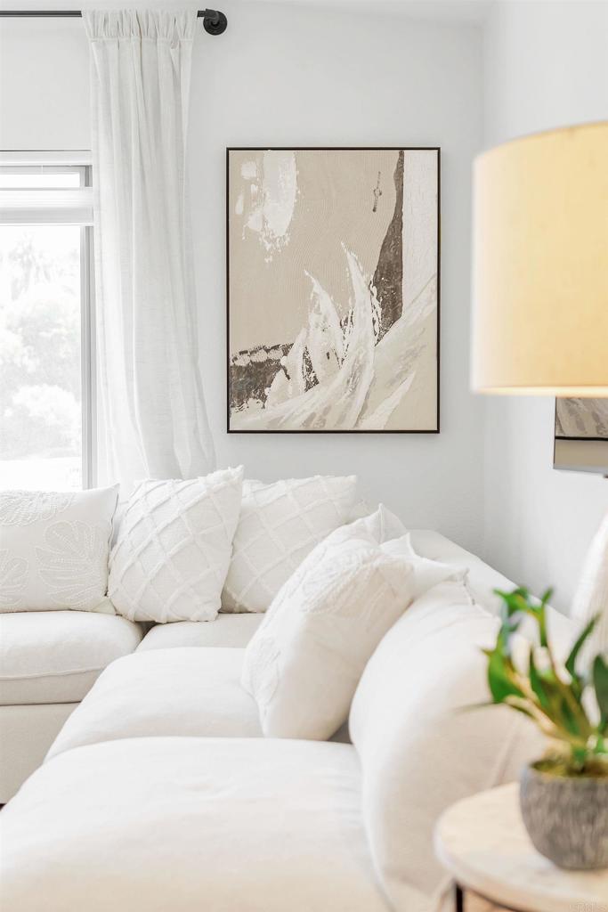 687 South Coast Highway 101, Unit 302 Encinitas, CA 92024 - Photo 23 of 32 a living room with a couch