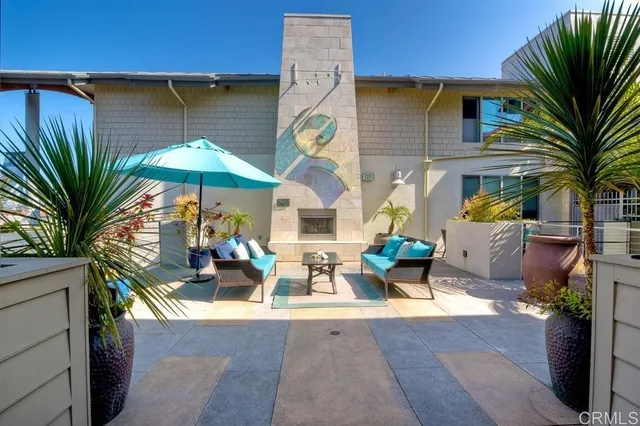 a view of a patio with couches and table and potted plants