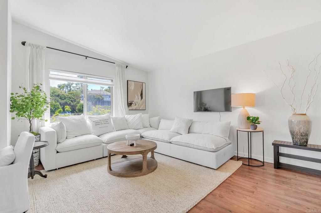687 South Coast Highway 101, Unit 302 Encinitas, CA 92024 - Photo 5 of 32 a living room with furniture and a large window