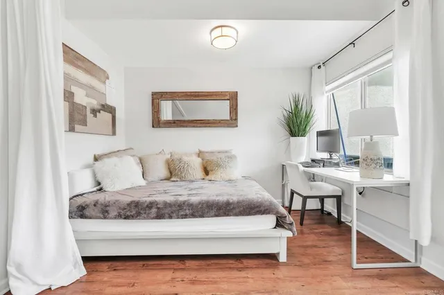 a living room with a bed and a table