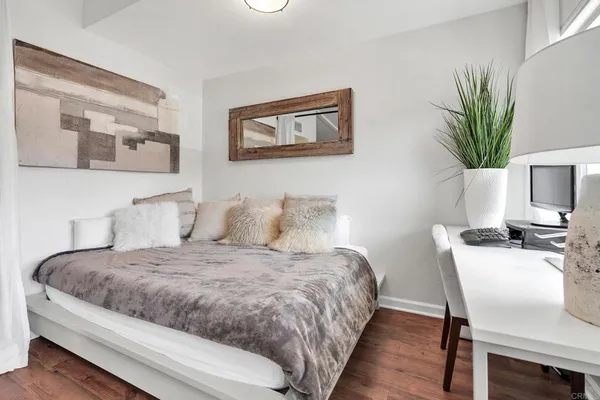 a bedroom with a bed and a potted plant