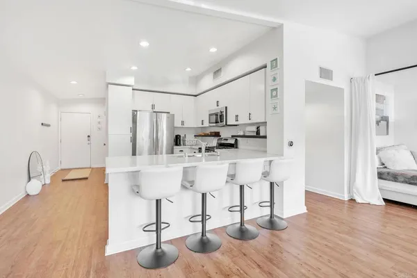 a view of kitchen with appliances and cabinets