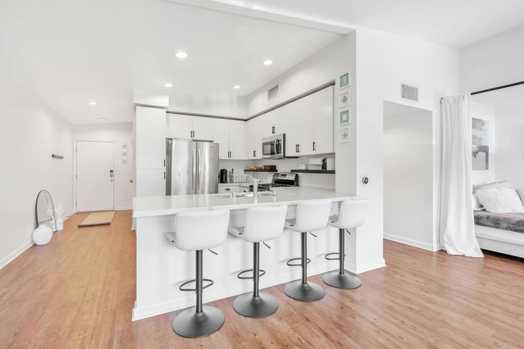 687 South Coast Highway 101, Unit 302 Encinitas, CA 92024 - Photo 10 of 32 a view of kitchen with appliances and cabinets