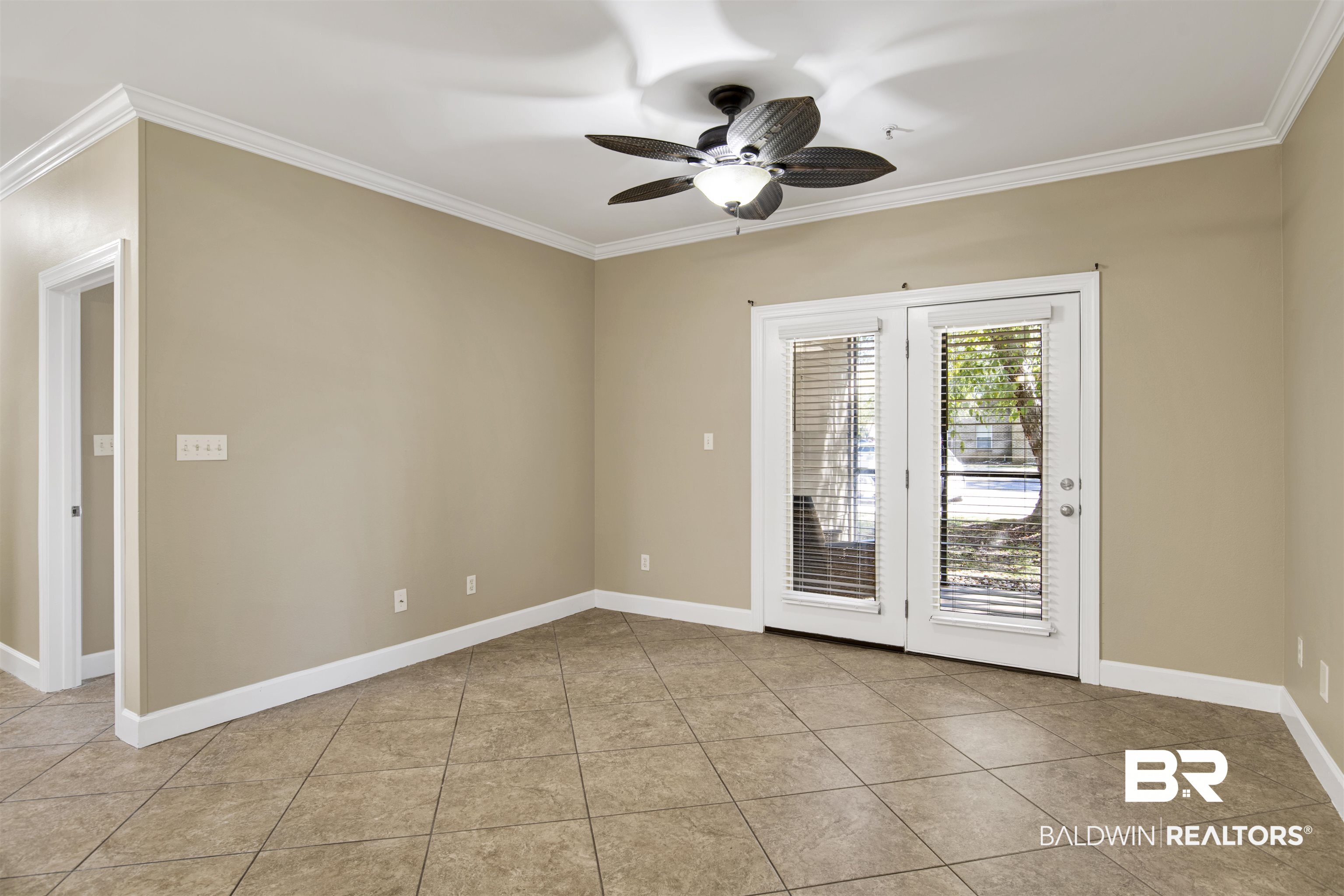 450 Park Avenue, Unit 202 Foley, AL 36535 - Photo 6 of 18 Spare room featuring crown molding, a ceiling fan, and light tile patterned flooring