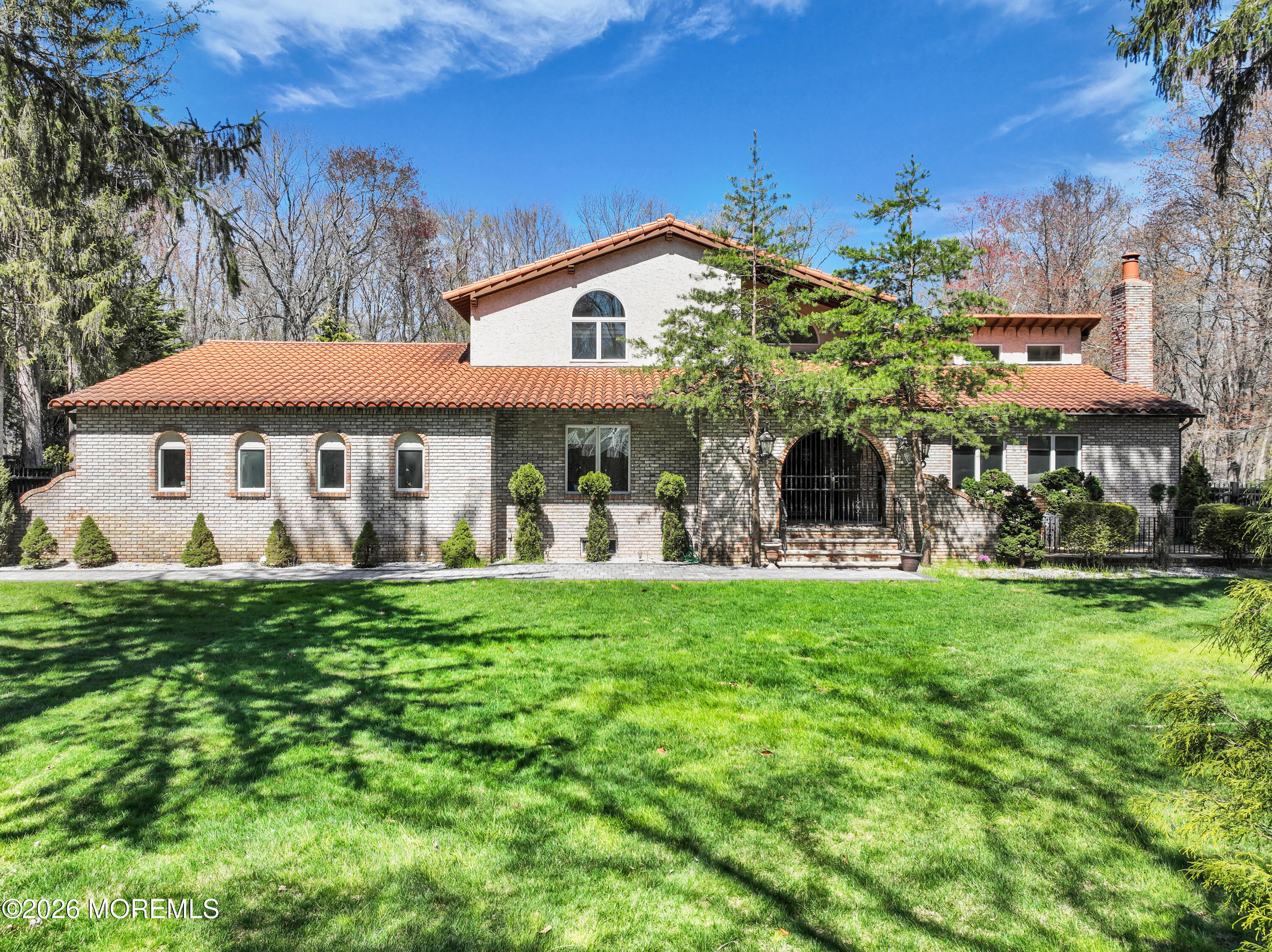 a front view of a house with a garden
