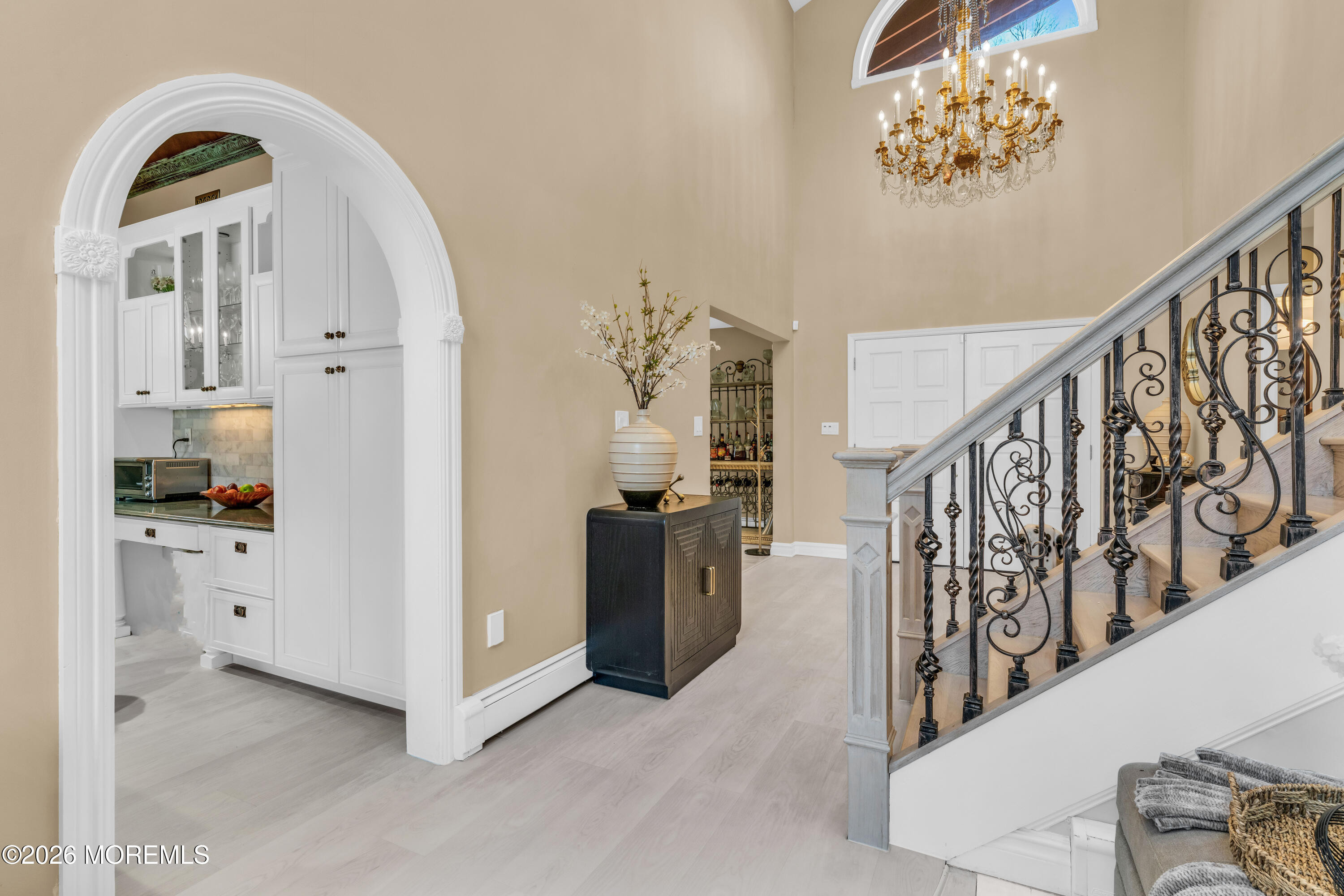12 Red Fox Run Manalapan, NJ 07726 - Photo 20 of 57 a view of a hallway with entryway windows chandelier and a kitchen view