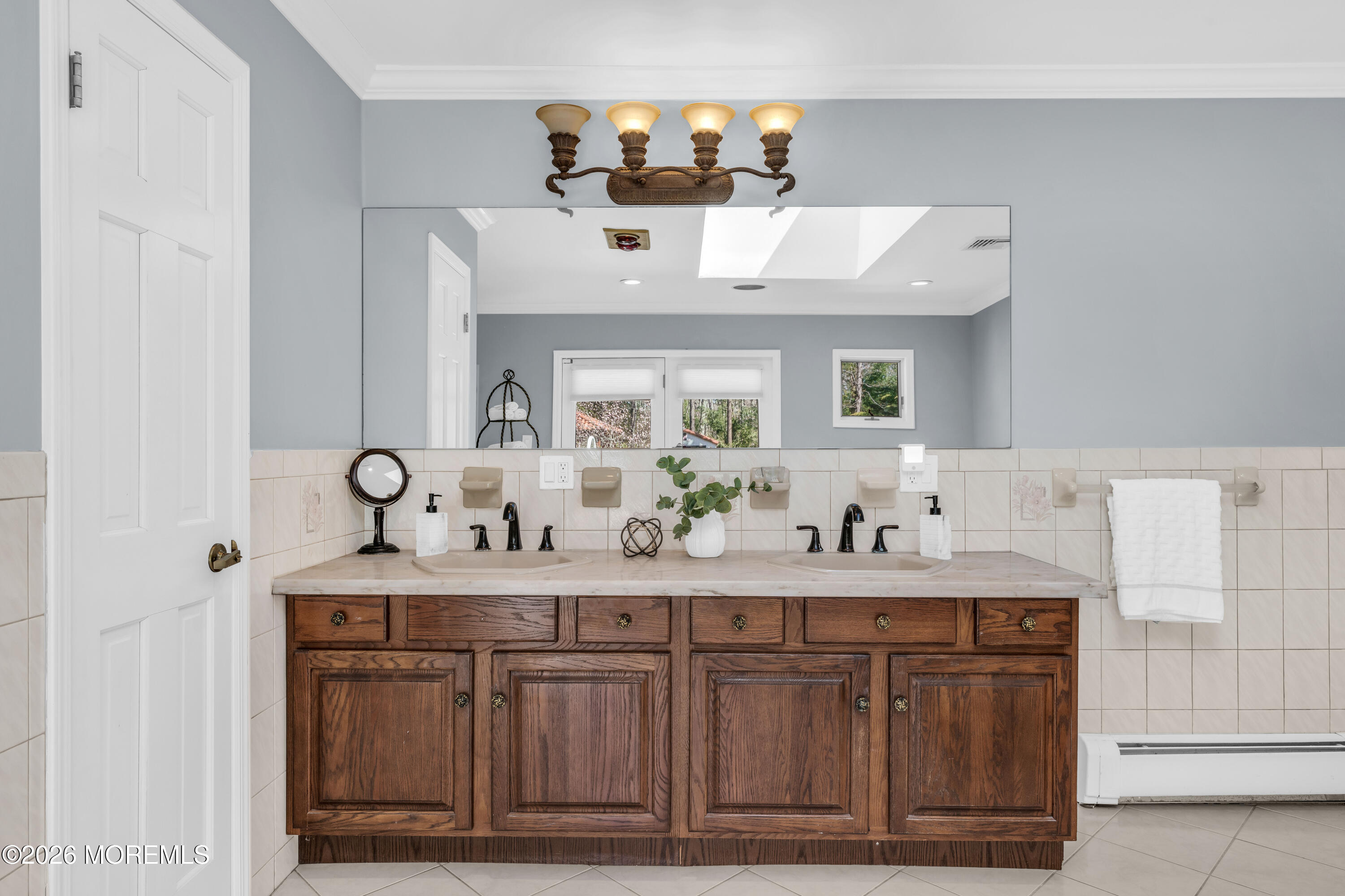 12 Red Fox Run Manalapan, NJ 07726 - Photo 25 of 57 a bathroom with a double vanity sink and a mirror