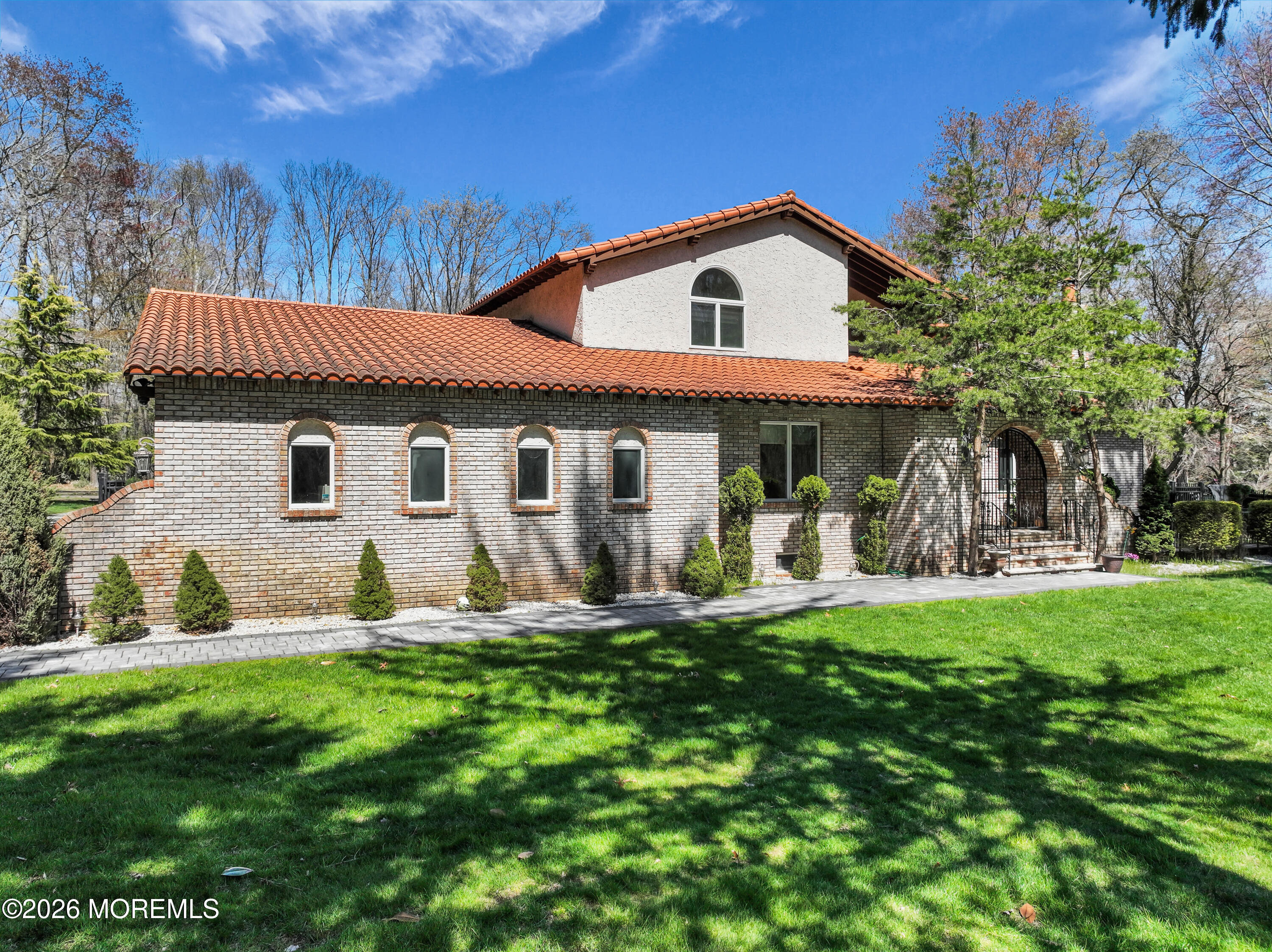 12 Red Fox Run Manalapan, NJ 07726 - Photo 3 of 57 a front view of a house with a yard and trees