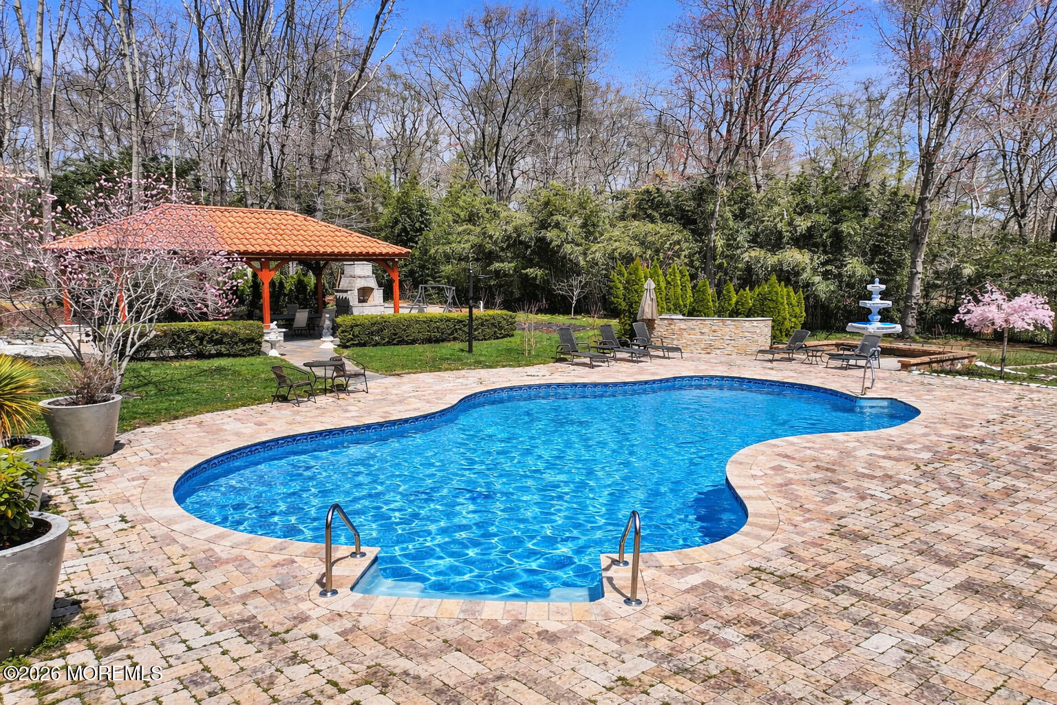 12 Red Fox Run Manalapan, NJ 07726 - Photo 44 of 57 a view of a swimming pool with a yard and potted plants