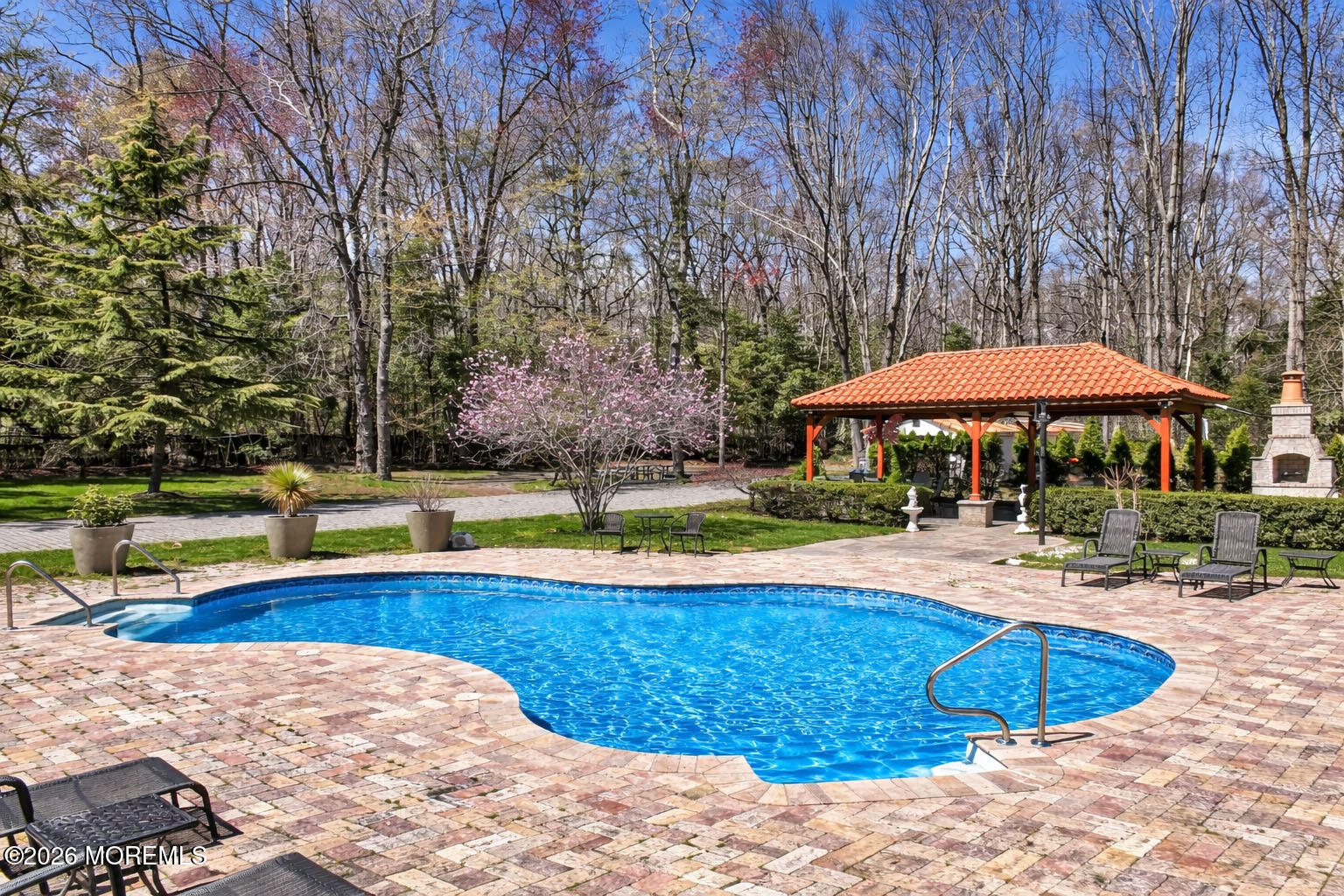12 Red Fox Run Manalapan, NJ 07726 - Photo 45 of 57 a view of a swimming pool with an outdoor space and seating area