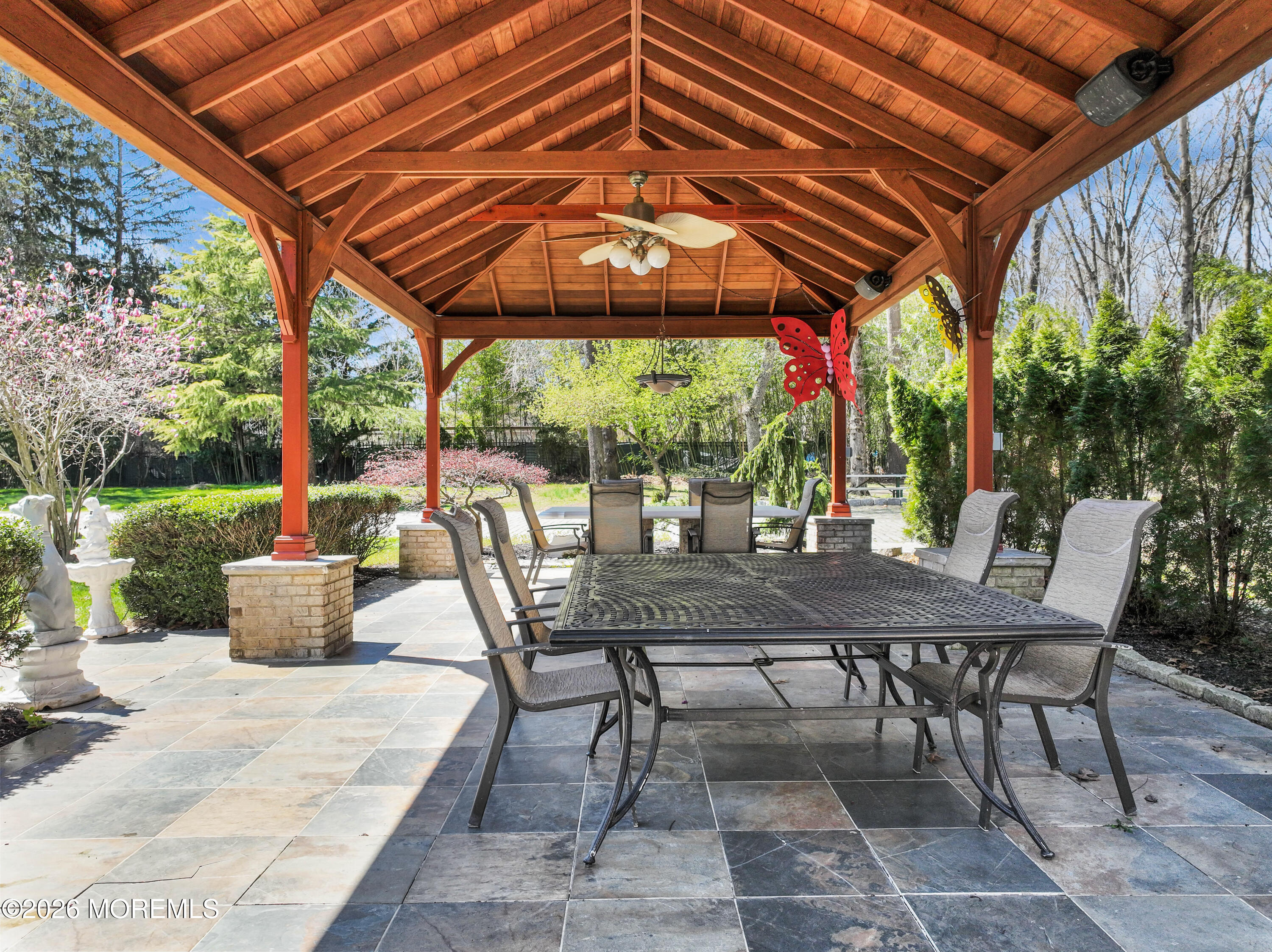 12 Red Fox Run Manalapan, NJ 07726 - Photo 49 of 57 a view of patio with a table and chairs under an umbrella