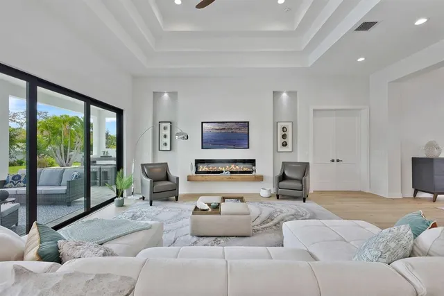 a living room with furniture and large windows