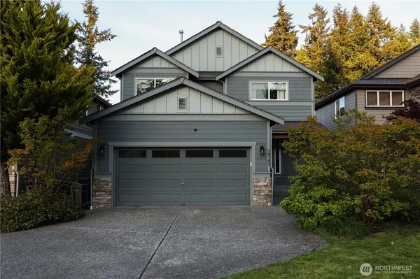 a front view of a house with a garden
