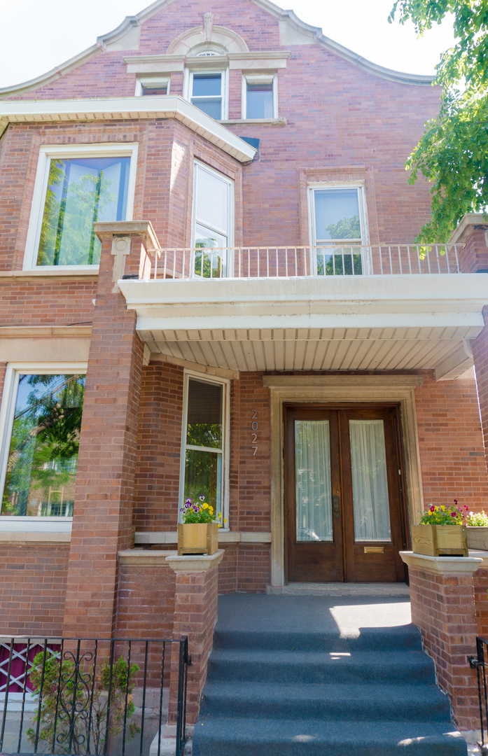 2027 West 22nd Place, Unit 3 Chicago, IL 60608 - Photo 1 of 16 a front view of a house with glass windows and plants