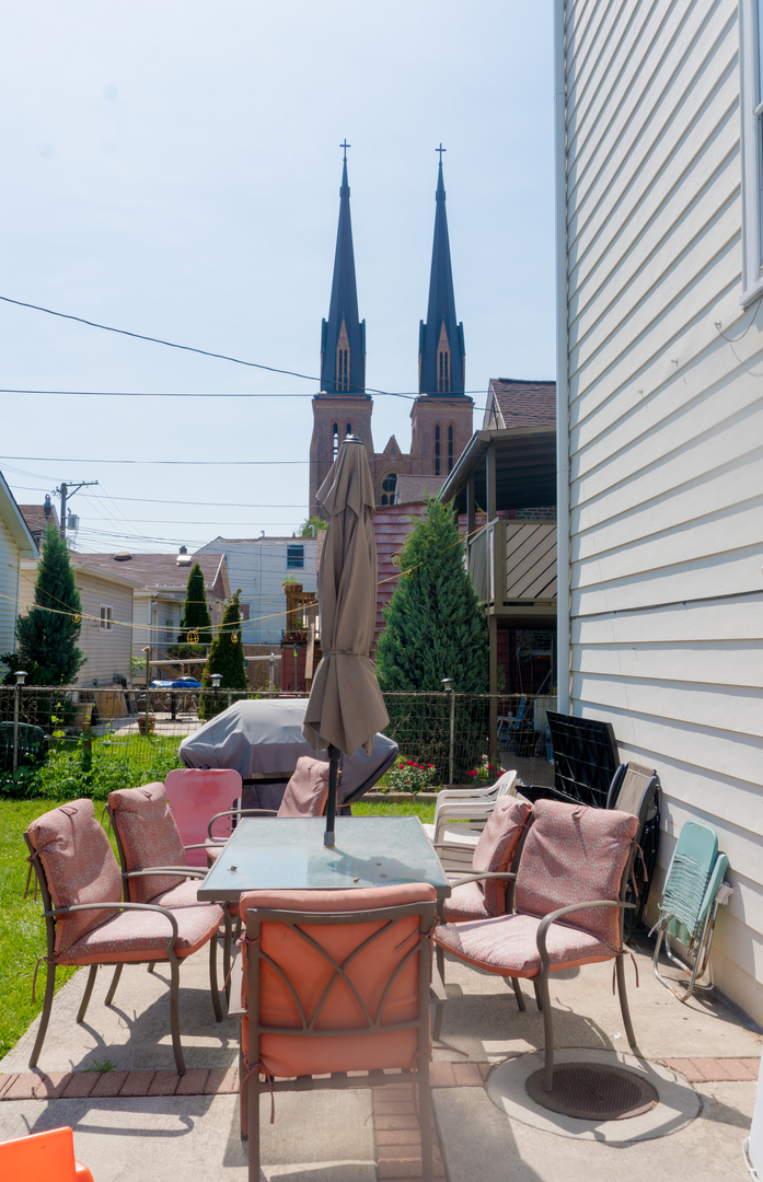 2027 West 22nd Place, Unit 3 Chicago, IL 60608 - Photo 15 of 16 a backyard of a house with barbeque oven table and chairs