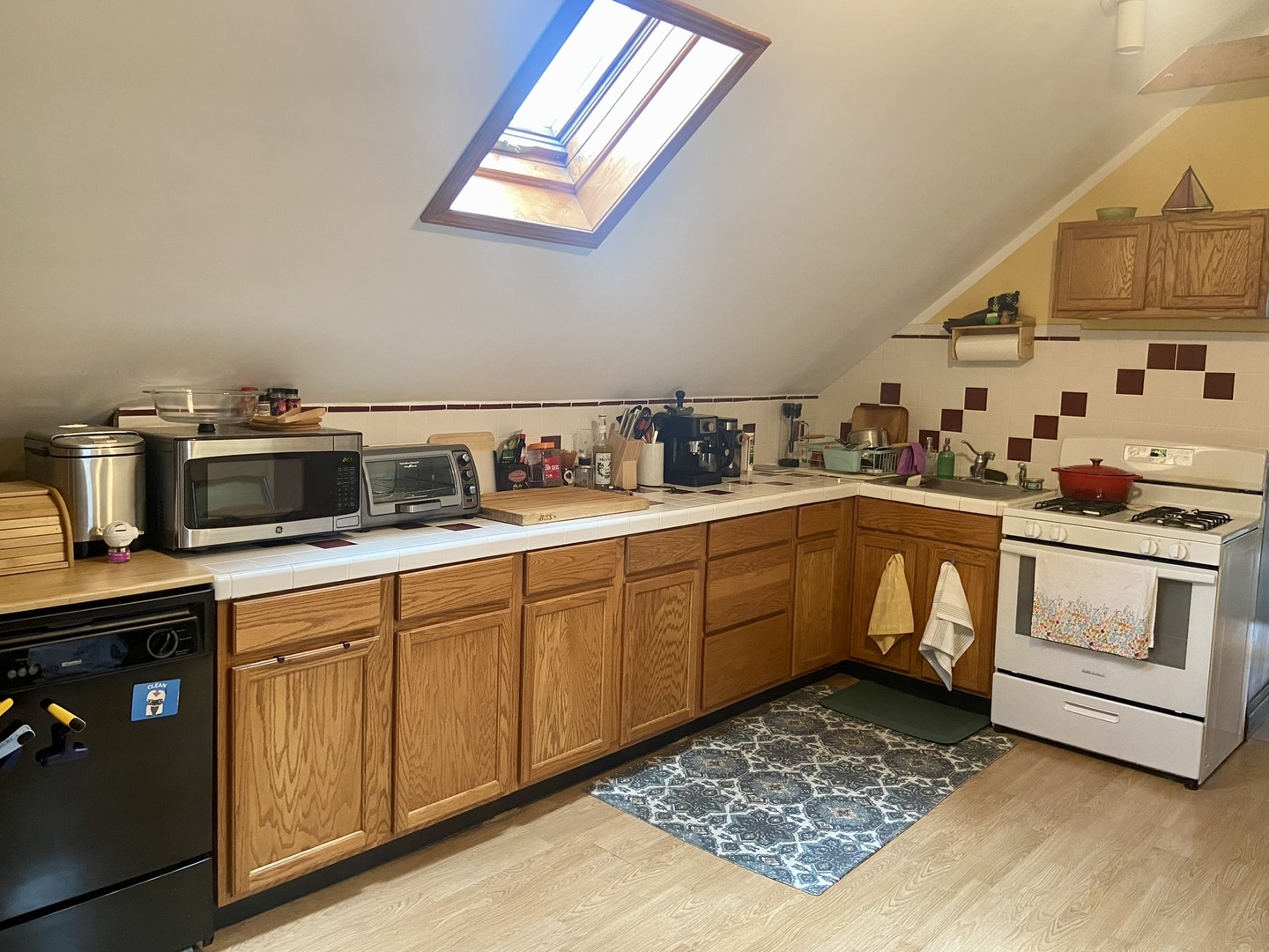 2027 West 22nd Place, Unit 3 Chicago, IL 60608 - Photo 7 of 16 a kitchen with a stove a sink and cabinets