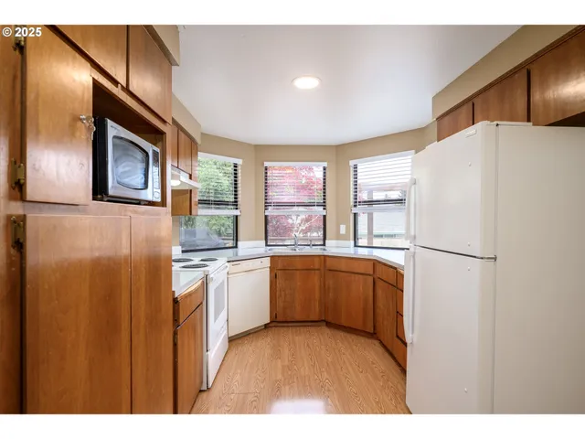 a kitchen with stainless steel appliances a refrigerator sink and cabinets