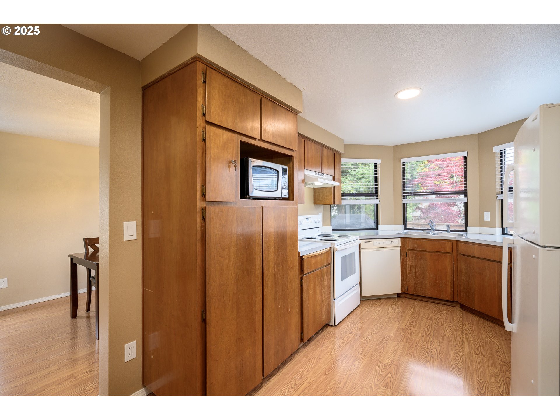 13675 Southwest Feiring Lane Tigard, OR 97223 - Photo 15 of 43 a kitchen with a refrigerator and a sink