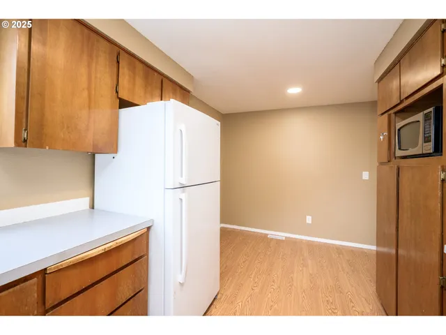 a kitchen with a refrigerator and a microwave