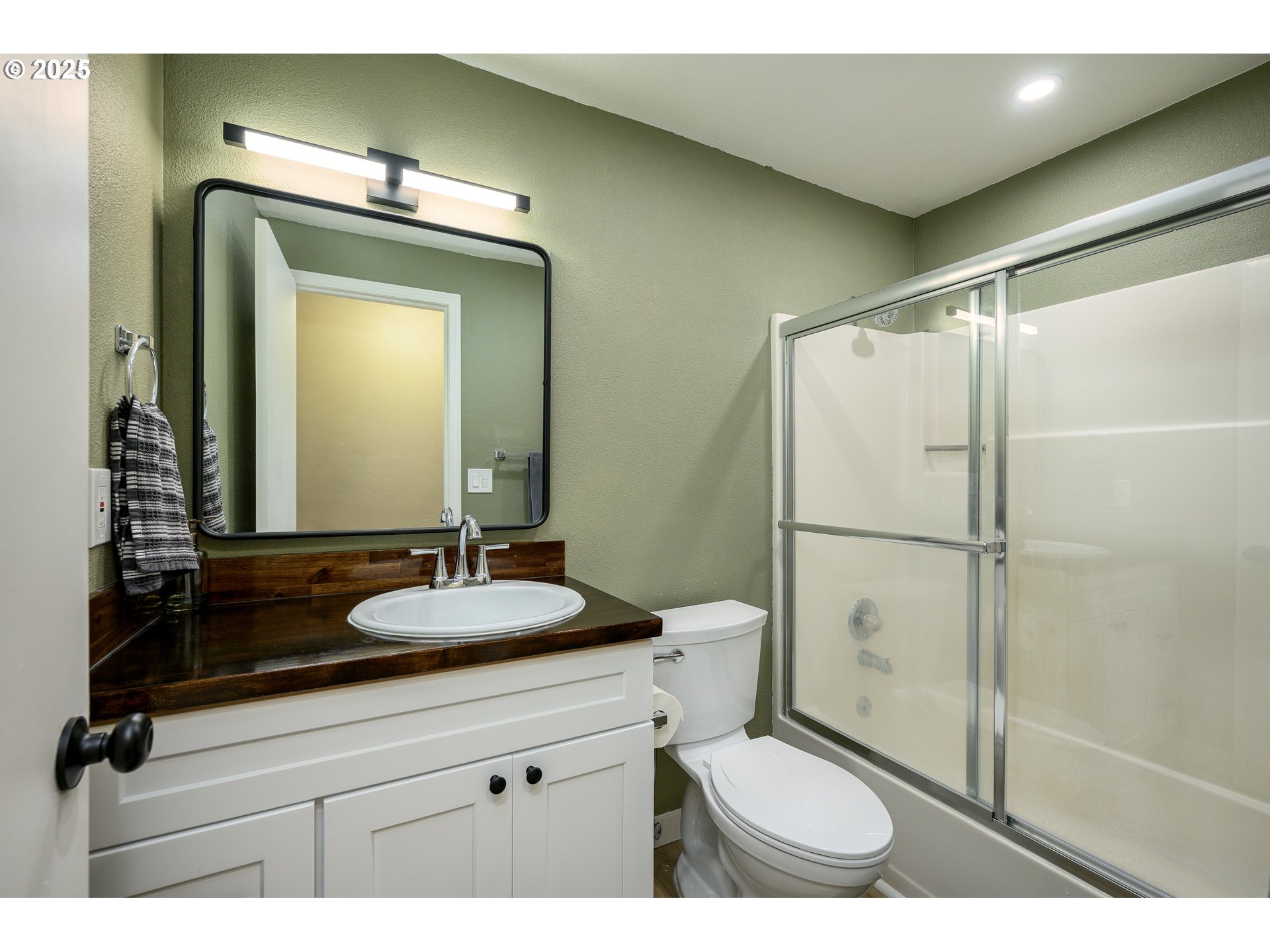 13675 Southwest Feiring Lane Tigard, OR 97223 - Photo 21 of 43 a bathroom with a granite countertop sink toilet and shower