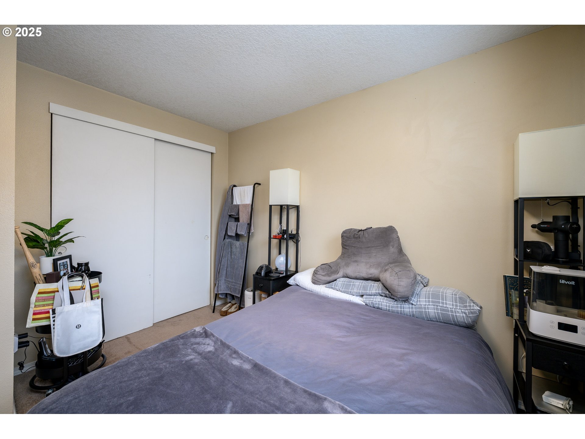 13675 Southwest Feiring Lane Tigard, OR 97223 - Photo 25 of 43 a bedroom with a bed and a potted plant on the dresser