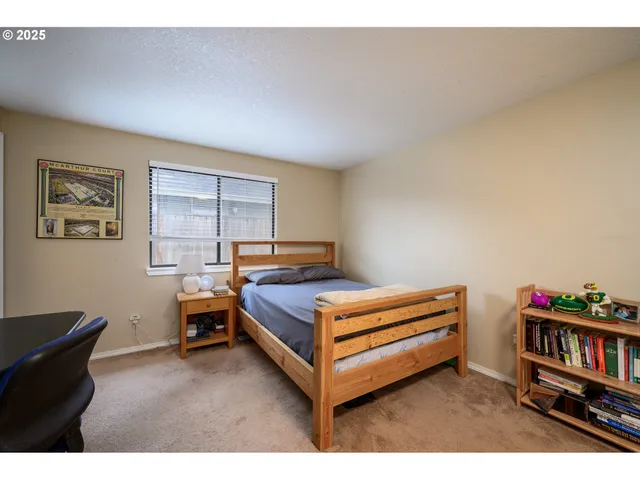 a bedroom with furniture and a book shelf