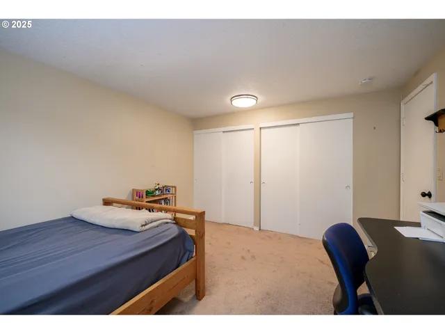 a bedroom with a bed and a table