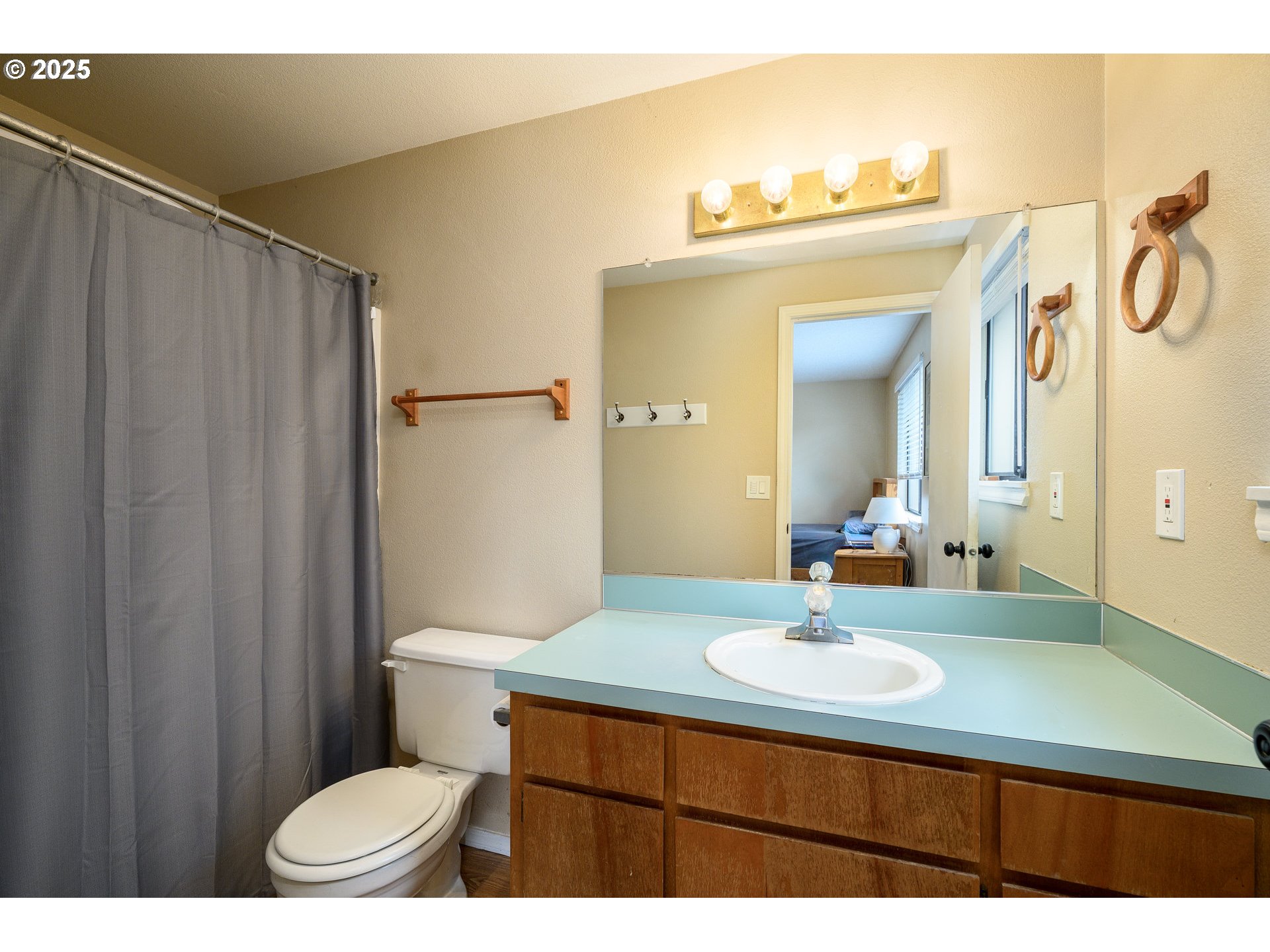 13675 Southwest Feiring Lane Tigard, OR 97223 - Photo 28 of 43 a bathroom with a sink a toilet a mirror and shower curtain