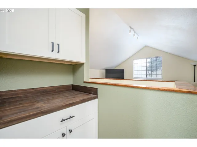 a kitchen with a cabinets and window