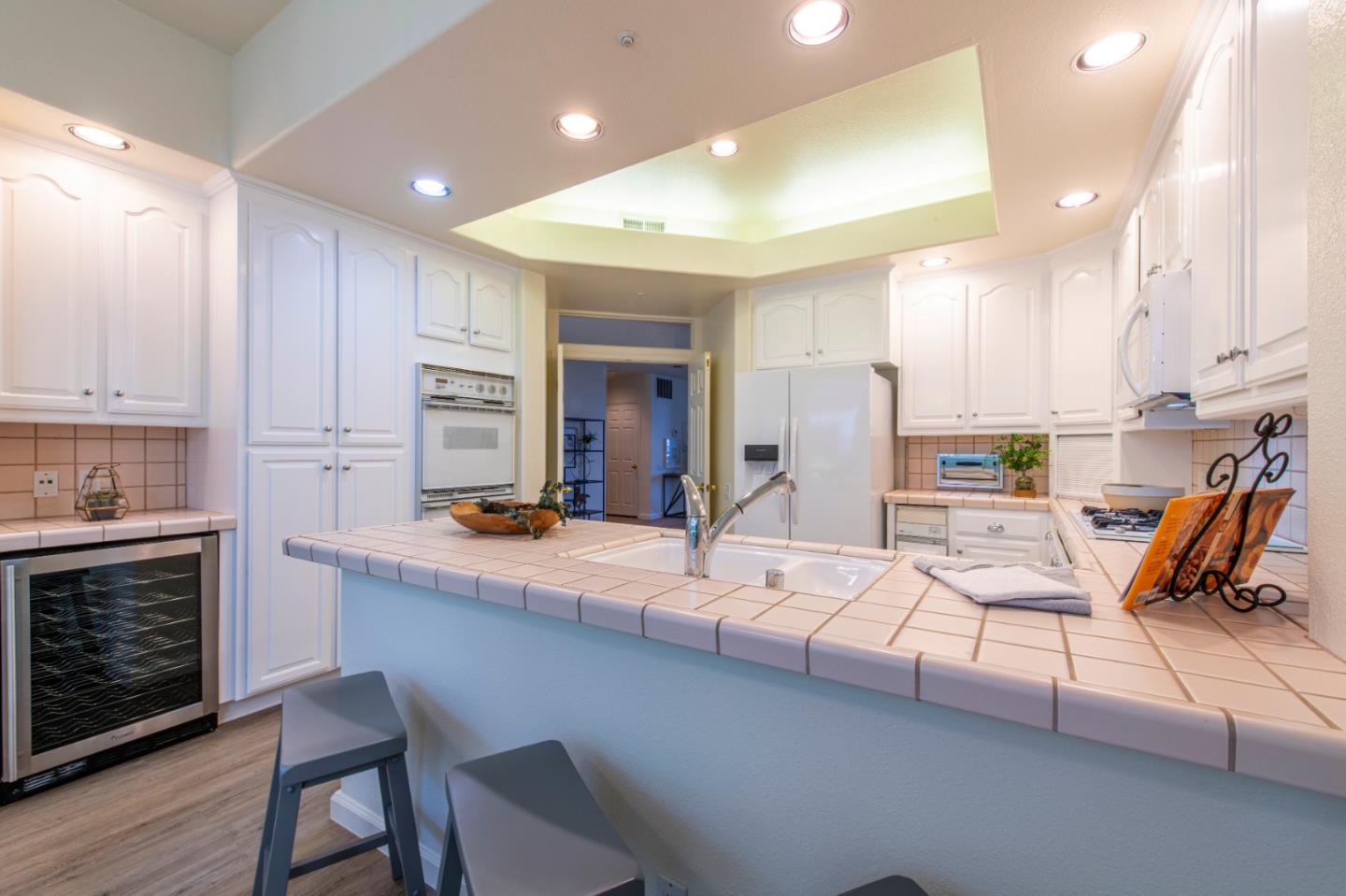 720 Promontory Point Lane, Unit 2104 Foster City, CA 94404 - Photo 17 of 27 a outdoor kitchen with a sink stove and chairs