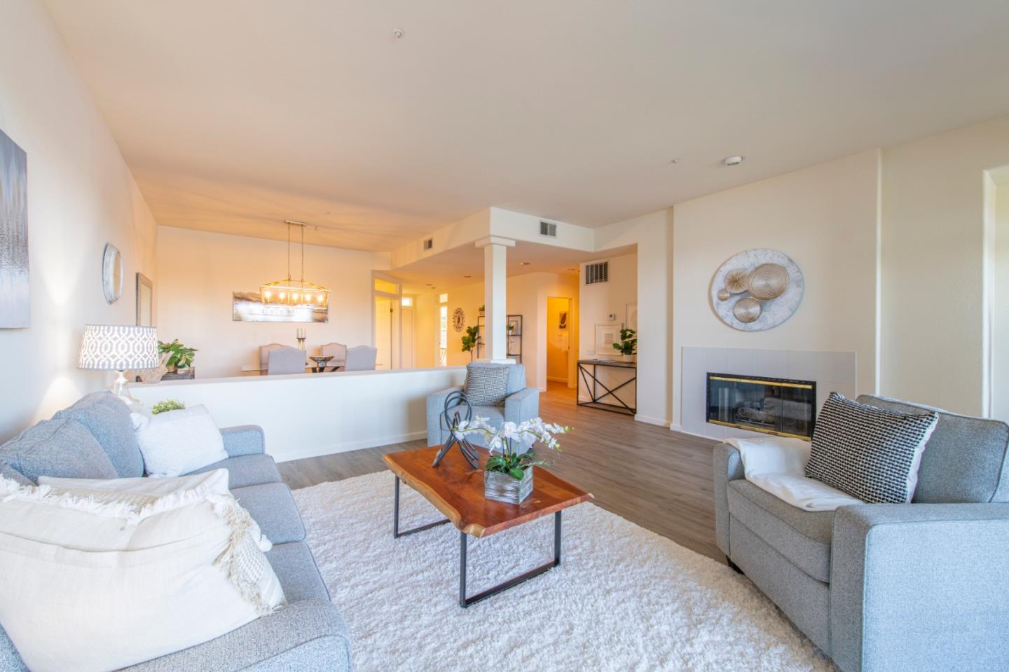 720 Promontory Point Lane, Unit 2104 Foster City, CA 94404 - Photo 5 of 27 a living room with furniture and a fireplace