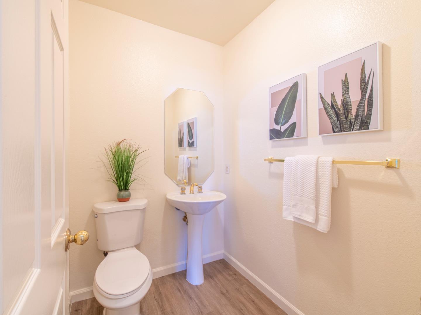 720 Promontory Point Lane, Unit 2104 Foster City, CA 94404 - Photo 9 of 27 a white toilet sitting next to a bathroom sink