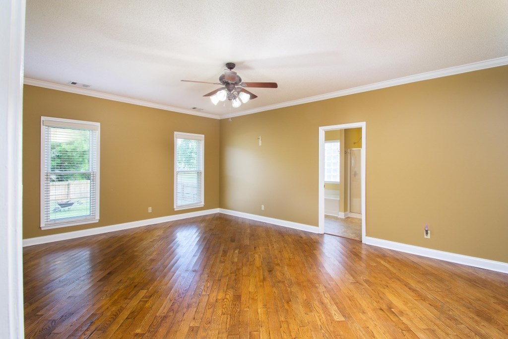 885 Jenkins Road, Unit 14 Forsyth, GA 31029 - Photo 12 of 33 a view of an empty room with wooden floor and a window