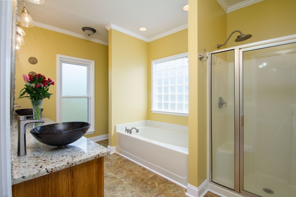 885 Jenkins Road, Unit 14 Forsyth, GA 31029 - Photo 14 of 33 a bathroom with a granite countertop sink a bathtub and shower