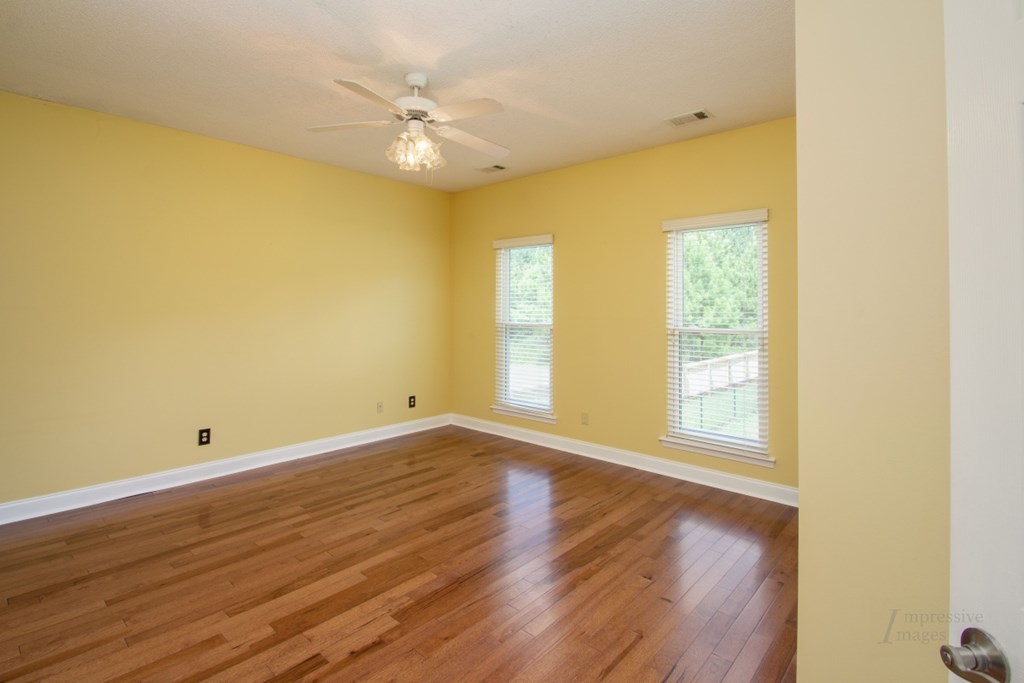 885 Jenkins Road, Unit 14 Forsyth, GA 31029 - Photo 17 of 33 a view of an empty room with wooden floor and a window