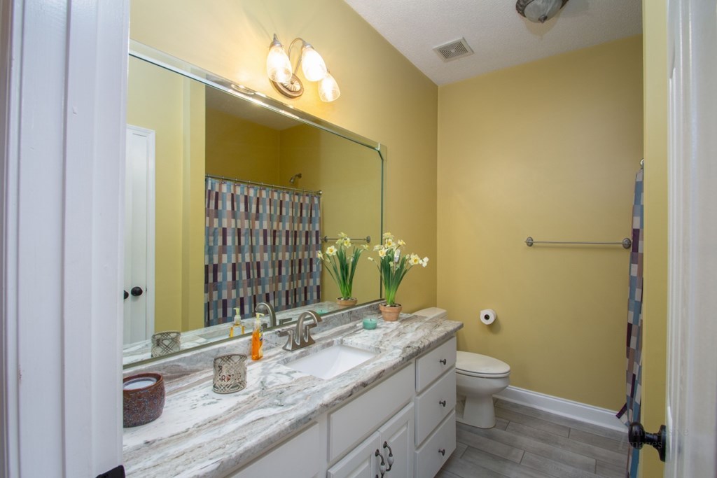 885 Jenkins Road, Unit 14 Forsyth, GA 31029 - Photo 21 of 33 a bathroom with a granite countertop sink toilet and shower