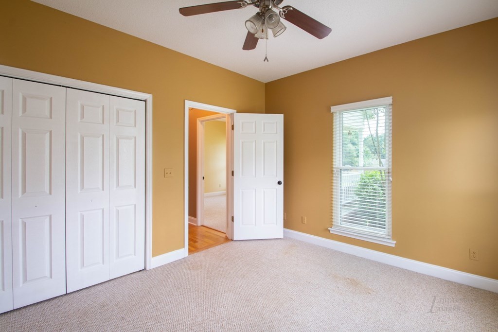 885 Jenkins Road, Unit 14 Forsyth, GA 31029 - Photo 23 of 33 an empty room with windows and fan