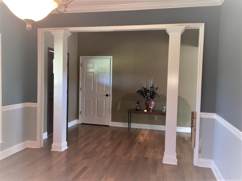 885 Jenkins Road, Unit 14 Forsyth, GA 31029 - Photo 31 of 33 a view of a hallway with wooden floor and a bathroom