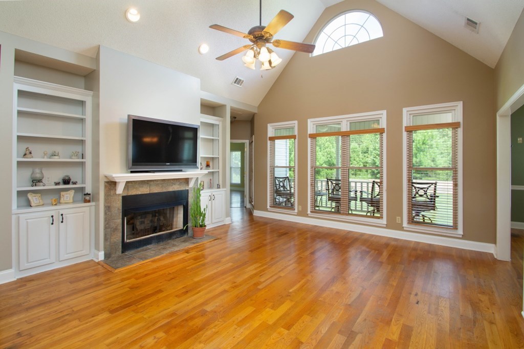 885 Jenkins Road, Unit 14 Forsyth, GA 31029 - Photo 6 of 33 a view of a livingroom with a fireplace a window and wooden floor
