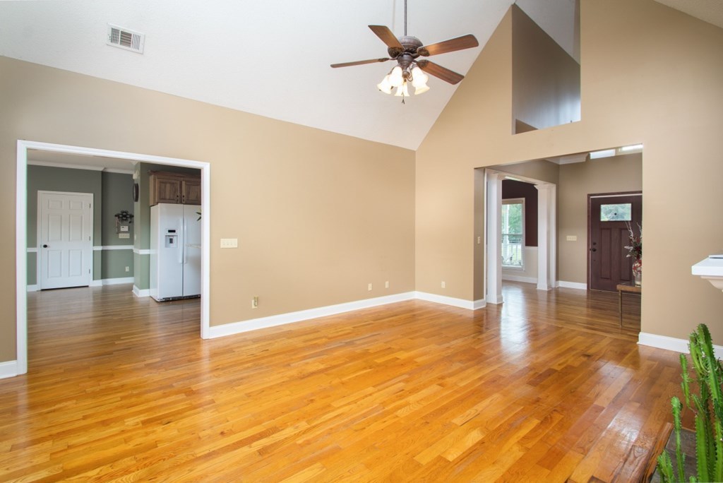 885 Jenkins Road, Unit 14 Forsyth, GA 31029 - Photo 7 of 33 wooden floor in an empty room with a window