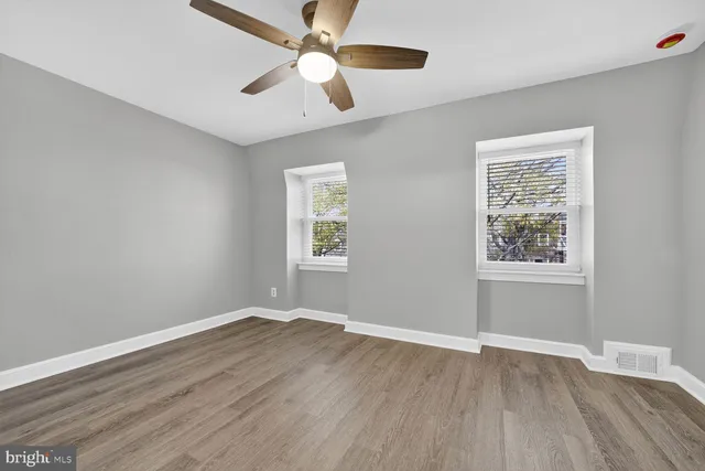 wooden floor in an empty room with a window