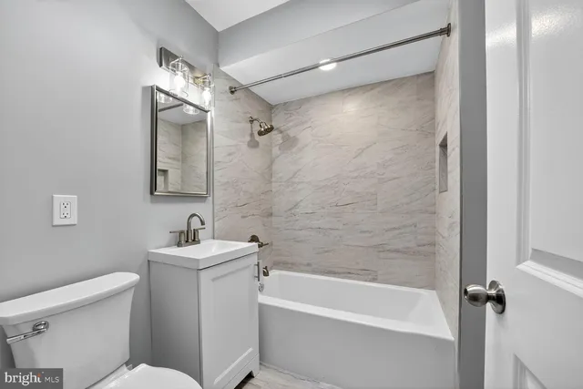 a bathroom with a toilet a sink and bathtub