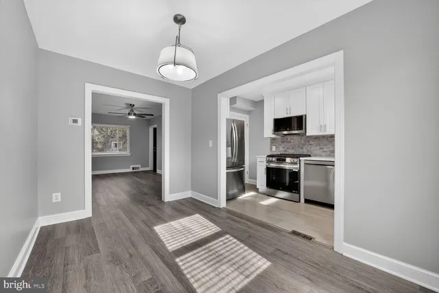 a view of kitchen with sink microwave refrigerator and stove