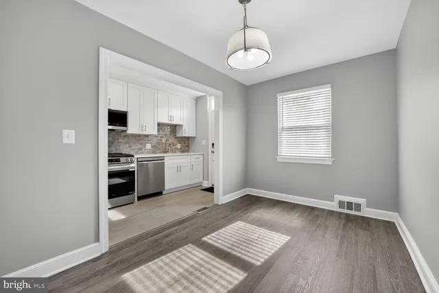 a kitchen with a stove a sink and a microwave