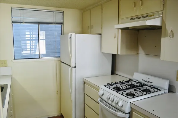 a kitchen with a stove and a window