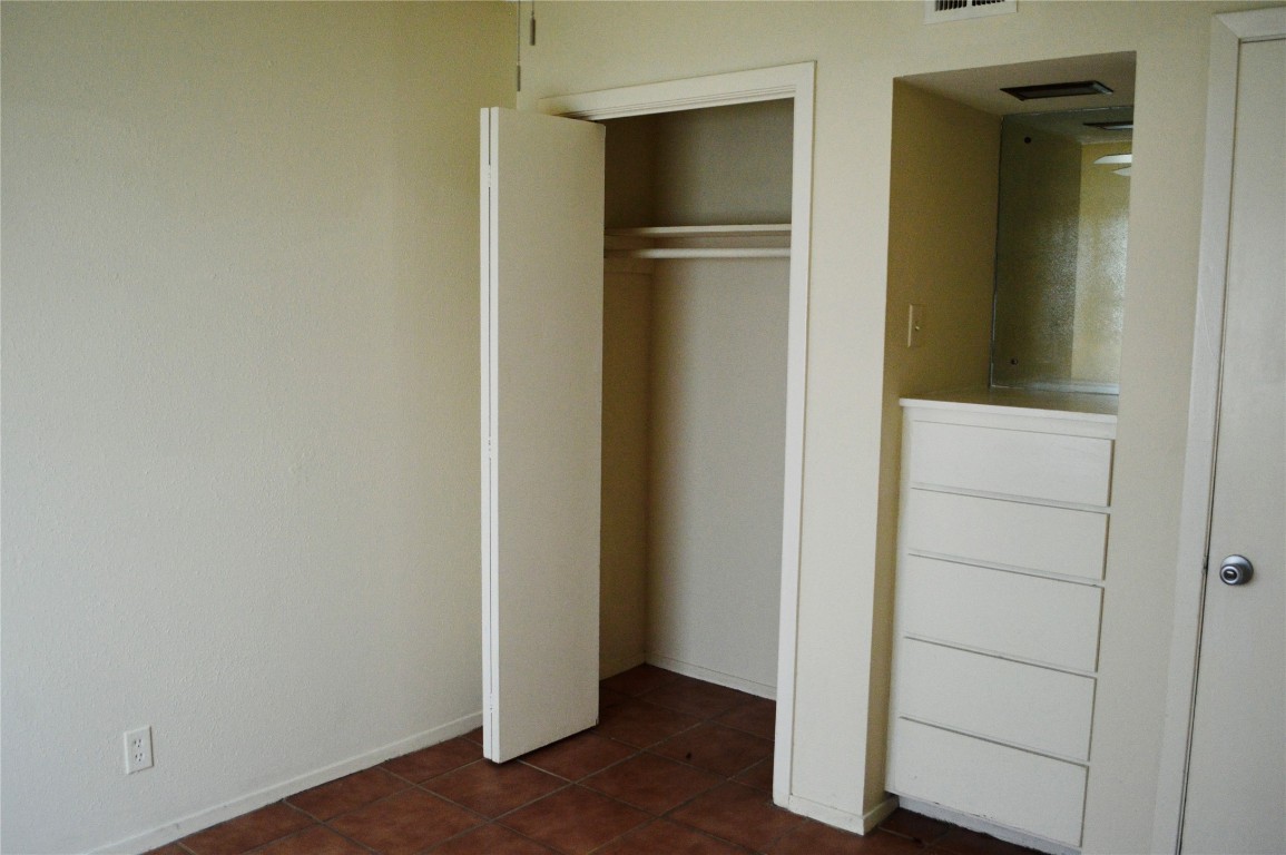 2610 Salado Street, Unit 110 Austin, TX 78705 - Photo 15 of 20 a view of walk in closet with empty racks