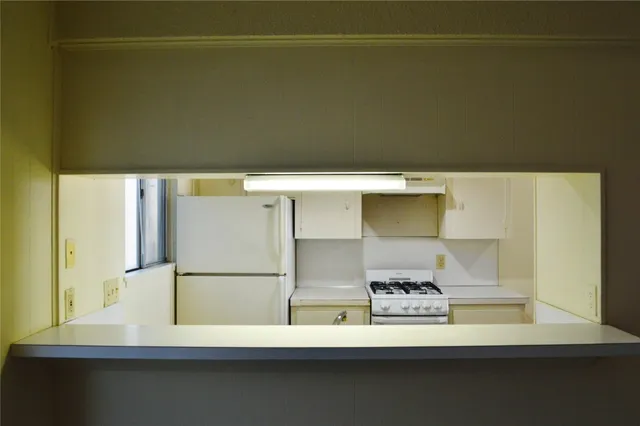 a kitchen with a sink and a refrigerator